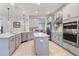 Modern kitchen with gray cabinets and walk-in pantry at 1861 Goblet Cove St, Kissimmee, FL 34746