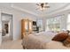 Bright main bedroom with large windows, a king-size bed, and access to the bath at 1861 Goblet Cove St, Kissimmee, FL 34746