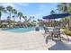 Resort-style pool with patio tables and umbrellas at 1861 Goblet Cove St, Kissimmee, FL 34746