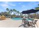 Relaxing pool area with patio tables and umbrellas at 1861 Goblet Cove St, Kissimmee, FL 34746