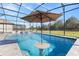 Beautiful pool with swim-up bar and patio umbrella at 1861 Goblet Cove St, Kissimmee, FL 34746