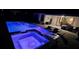 Night view of a pool and spa with blue lighting at 1861 Goblet Cove St, Kissimmee, FL 34746