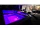 Night view of a pool and spa with purple lighting at 1861 Goblet Cove St, Kissimmee, FL 34746