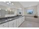 Bathroom with double vanity, soaking tub, and walk-in shower at 1954 Filly Trl, Oviedo, FL 32765