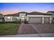 Two-story house with a three-car garage, and a landscaped front yard at 1954 Filly Trl, Oviedo, FL 32765