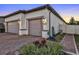 Two-car garage with paver driveway and landscape at 1954 Filly Trl, Oviedo, FL 32765