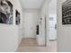 Hallway with coat rack and door to laundry room at 1954 Filly Trl, Oviedo, FL 32765