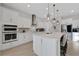 Modern white kitchen with stainless steel appliances and island at 1954 Filly Trl, Oviedo, FL 32765