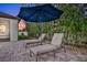 Lush patio with lounge chairs and umbrella for relaxation at 1954 Filly Trl, Oviedo, FL 32765