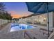 Relaxing poolside view with lounge chairs and patio umbrella at 1954 Filly Trl, Oviedo, FL 32765