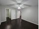 Bright bedroom with dark hardwood floors and ceiling fan at 1979 Summer Club Dr # 309, Oviedo, FL 32765