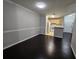 Dining room with dark laminate floors and view into a galley kitchen at 1979 Summer Club Dr # 309, Oviedo, FL 32765