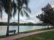 Scenic lake view with a bench and walking path at 1979 Summer Club Dr # 309, Oviedo, FL 32765