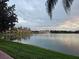 Peaceful lakefront property with community buildings in the background at 1979 Summer Club Dr # 309, Oviedo, FL 32765