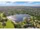 Aerial view of lakefront property with golf course and houses at 237 Hazeltine Dr, Debary, FL 32713