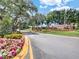 Entrance to DeBary Golf & Country Club, with curving road and landscaping at 237 Hazeltine Dr, Debary, FL 32713