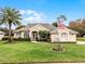 One-story home with palm tree and American flag at 237 Hazeltine Dr, Debary, FL 32713