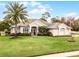 One-story home with palm tree and American flag at 237 Hazeltine Dr, Debary, FL 32713