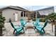 Charming fire pit area with teal chairs, perfect for outdoor gatherings at 237 Hazeltine Dr, Debary, FL 32713