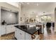 Open kitchen with white cabinets, black countertops, and an island at 237 Hazeltine Dr, Debary, FL 32713