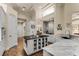 White kitchen with marble countertops, island, and breakfast bar at 237 Hazeltine Dr, Debary, FL 32713