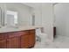 Bathroom with neutral walls, tile floors, and wood vanity with a large mirror at 2555 Sand Arbor Cir, Orlando, FL 32824