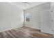 Bedroom featuring a window with blinds and laminate wood flooring at 2555 Sand Arbor Cir, Orlando, FL 32824