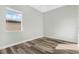 Bedroom featuring a window with blinds and laminate wood flooring at 2555 Sand Arbor Cir, Orlando, FL 32824