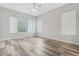 Bright bedroom featuring wood flooring, a ceiling fan, and large windows offering natural light at 2555 Sand Arbor Cir, Orlando, FL 32824