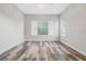 Bedroom featuring modern wood flooring, a ceiling fan, and ample natural light from the windows at 2555 Sand Arbor Cir, Orlando, FL 32824