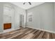 Bedroom with wood flooring, a window with blinds, and doors to a bathroom and closet at 2555 Sand Arbor Cir, Orlando, FL 32824