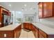 Open kitchen featuring stainless steel appliances, an island, and wood cabinetry at 2555 Sand Arbor Cir, Orlando, FL 32824