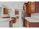 Spacious kitchen featuring stainless steel appliances, a central island, and wood cabinetry at 2555 Sand Arbor Cir, Orlando, FL 32824