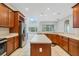 Open kitchen featuring stainless steel appliances, an island, and wood cabinetry at 2555 Sand Arbor Cir, Orlando, FL 32824