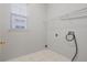 A clean laundry room with tile flooring, and a window for natural light at 2555 Sand Arbor Cir, Orlando, FL 32824