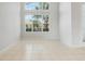 Bright, airy living room featuring tile floors and a large window allowing natural light to fill the room at 2555 Sand Arbor Cir, Orlando, FL 32824