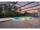 Private backyard pool and spa with brick pavers and screens provide an evening oasis at 2555 Sand Arbor Cir, Orlando, FL 32824