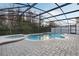 Relaxing screen-enclosed backyard pool with spa and brick pavers provides a private oasis for Florida living at 2555 Sand Arbor Cir, Orlando, FL 32824