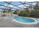 Screened-in pool and spa with brick pavers in a private backyard setting is perfect for enjoying the Florida lifestyle at 2555 Sand Arbor Cir, Orlando, FL 32824