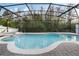 Backyard screened-in pool with spa offers a relaxing oasis for cooling off and enjoying the outdoors at 2555 Sand Arbor Cir, Orlando, FL 32824