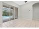 Neutral-toned room with sliding glass doors leading to a screened-in pool area at 2555 Sand Arbor Cir, Orlando, FL 32824