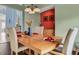 Dining room with a wood table, six chairs, and an accent wall at 257 Bonville Dr, Davenport, FL 33897