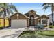 One-story house with a light brown exterior and a two-car garage at 257 Bonville Dr, Davenport, FL 33897