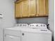 Laundry room with washer, dryer, and wood cabinets at 257 Bonville Dr, Davenport, FL 33897