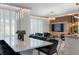 Open concept dining room showcasing a sleek table and chairs, adjacent to a living area at 2600 Reading Trl, Kissimmee, FL 34746