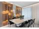 Contemporary dining room boasting a stylish table, dark chairs, and a wood accent wall at 2600 Reading Trl, Kissimmee, FL 34746