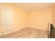 Simple bedroom with hardwood floors and large window at 2642 Maggiore Cir, Kissimmee, FL 34746