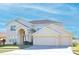 Two-story house with a three-car garage and manicured lawn at 2642 Maggiore Cir, Kissimmee, FL 34746