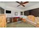 Bedroom with a wooden bed frame, dresser, and TV at 3107 S Park Ave, Sanford, FL 32773