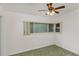 Simple bedroom with ceiling fan and neutral colored carpet at 3107 S Park Ave, Sanford, FL 32773